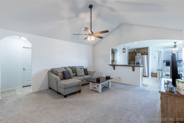 11042 N 120th Ave E, Owasso, OK 74055 - living area featuring a ceiling fan, arched walkways, light colored carpet, and vaulted ceiling