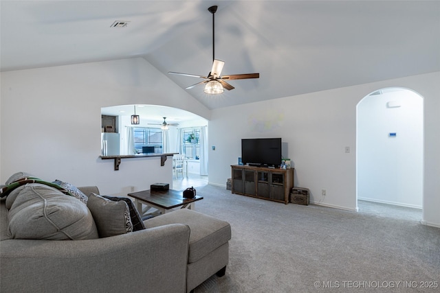 11042 N 120th Ave E, Owasso, OK 74055 - living room with arched walkways, a ceiling fan, vaulted ceiling, and carpet flooring