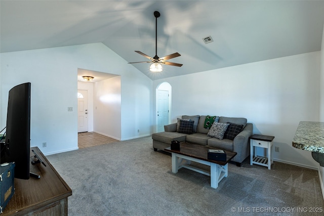 11042 N 120th Ave E, Owasso, OK 74055 - carpeted living room with lofted ceiling, ceiling fan, and arched walkways