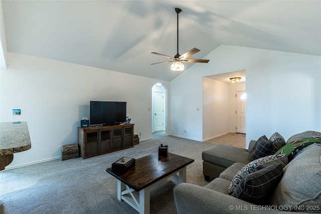 11042 N 120th Ave E, Owasso, OK 74055 - carpeted living area with lofted ceiling, arched walkways, and a ceiling fan