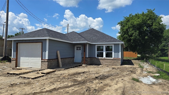217 E Virgin St, Tulsa, OK 74106 - ranch-style home with brick siding, a shingled roof, and a garage
