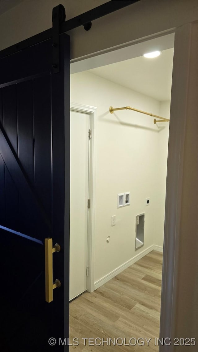 217 E Virgin St, Tulsa, OK 74106 - washroom with hookup for a washing machine, light wood finished floors, hookup for an electric dryer, and a barn door
