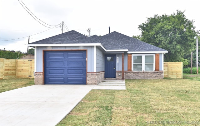 217 E Virgin St, Tulsa, OK 74106 - view of front of home featuring a shingled roof, a garage, brick siding, and concrete driveway