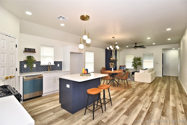 217 E Virgin St, Tulsa, OK 74106 - kitchen with stainless steel dishwasher, black range with gas stovetop, white cabinetry, light wood-style flooring, and light countertops