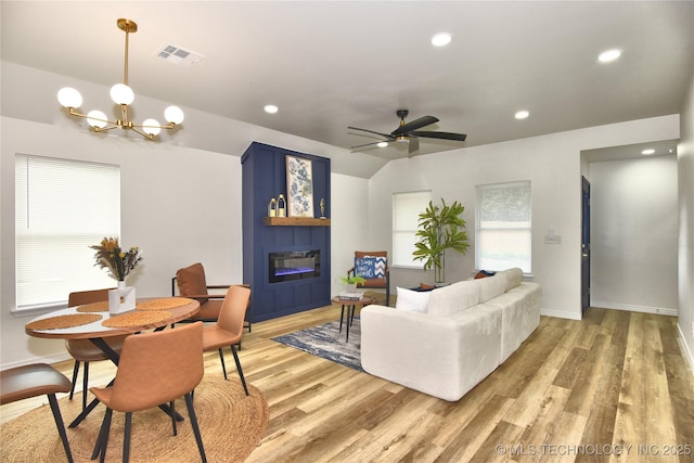 217 E Virgin St, Tulsa, OK 74106 - living area with a glass covered fireplace, light wood-type flooring, a chandelier, recessed lighting, and ceiling fan