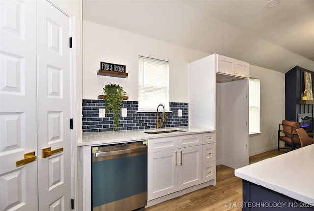 217 E Virgin St, Tulsa, OK 74106 - kitchen with dishwashing machine, open shelves, light countertops, light wood-style flooring, and tasteful backsplash
