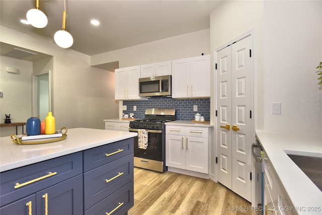 217 E Virgin St, Tulsa, OK 74106 - kitchen featuring appliances with stainless steel finishes, white cabinetry, tasteful backsplash, and light countertops