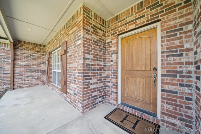 8483 N 68th E Ave, Owasso, OK 74055 - view of exterior entry with brick siding and a porch