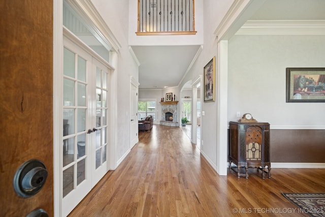 8483 N 68th E Ave, Owasso, OK 74055 - entrance foyer with french doors, wood finished floors, ornamental molding, a stone fireplace, and a high ceiling