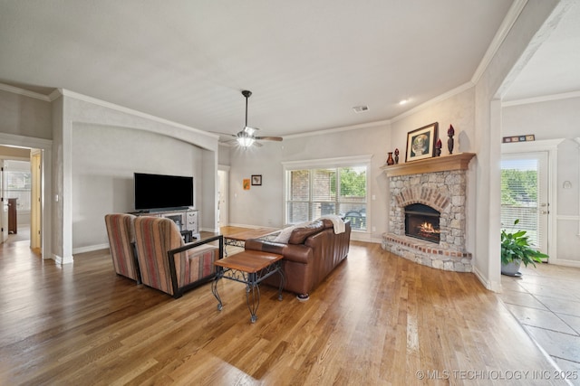 8483 N 68th E Ave, Owasso, OK 74055 - living area with wood finished floors, a fireplace, healthy amount of natural light, crown molding, and a ceiling fan