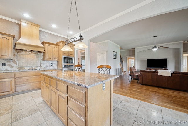 8483 N 68th E Ave, Owasso, OK 74055 - kitchen with premium range hood, oven, built in microwave, light brown cabinets, and crown molding