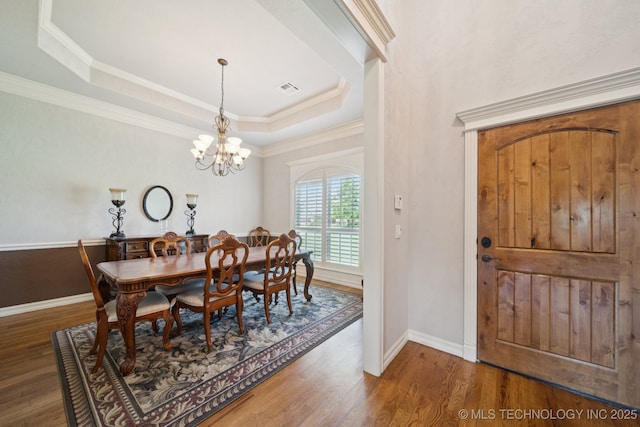 8483 N 68th E Ave, Owasso, OK 74055 - dining space with wood finished floors, a raised ceiling, ornamental molding, and a chandelier
