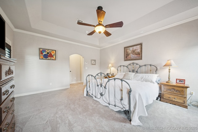 8483 N 68th E Ave, Owasso, OK 74055 - carpeted bedroom featuring a tray ceiling, arched walkways, ornamental molding, and a ceiling fan