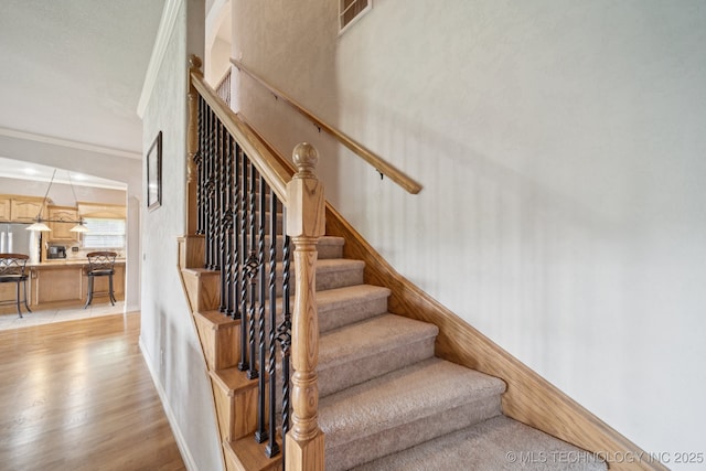8483 N 68th E Ave, Owasso, OK 74055 - staircase featuring wood finished floors and ornamental molding