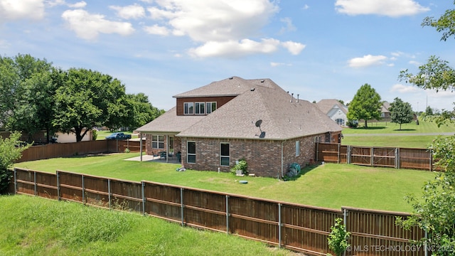 8483 N 68th E Ave, Owasso, OK 74055 - rear view of house featuring a patio, brick siding, a fenced backyard, and a shingled roof