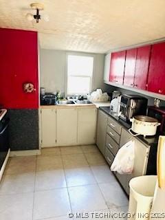 213 W Pine St, Coweta, OK 74429 - kitchen with light tile patterned floors and range