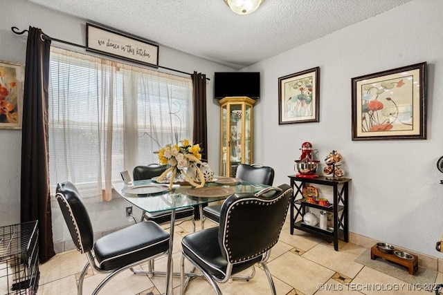 2528 W Commercial St, Broken Arrow, OK 74012 - dining area featuring a textured ceiling and light tile patterned floors