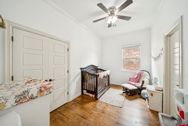 905 W Elmira St, Broken Arrow, OK 74012 - bedroom with ornamental molding, wood finished floors, a ceiling fan, and a nursery area