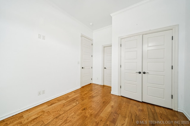 905 W Elmira St, Broken Arrow, OK 74012 - unfurnished bedroom with crown molding, wood finished floors, and a closet