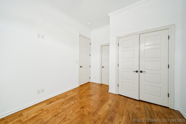 905 W Elmira St, Broken Arrow, OK 74012 - unfurnished bedroom with crown molding, wood finished floors, and a closet
