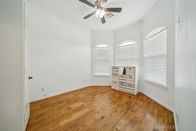 905 W Elmira St, Broken Arrow, OK 74012 - empty room featuring ceiling fan, ornamental molding, healthy amount of natural light, and wood finished floors