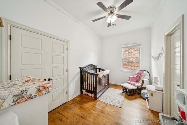 905 W Elmira St, Broken Arrow, OK 74012 - bedroom featuring ornamental molding, wood finished floors, ceiling fan, and a nursery area