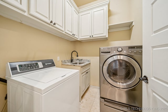 905 W Elmira St, Broken Arrow, OK 74012 - laundry room featuring washing machine and dryer, cabinet space, and light tile patterned flooring