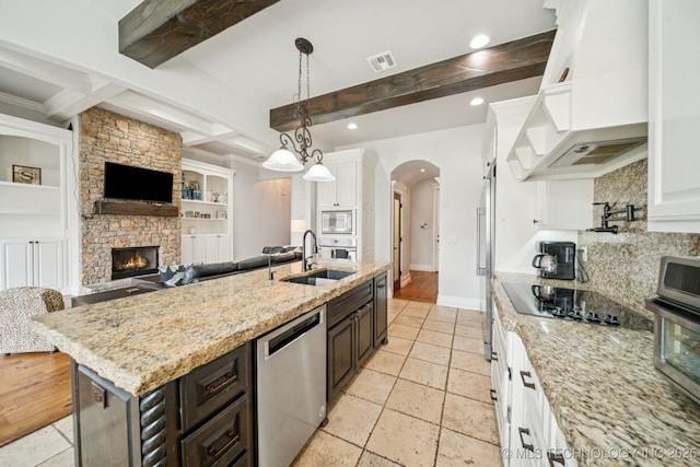 905 W Elmira St, Broken Arrow, OK 74012 - kitchen with appliances with stainless steel finishes, custom range hood, open floor plan, beam ceiling, and arched walkways