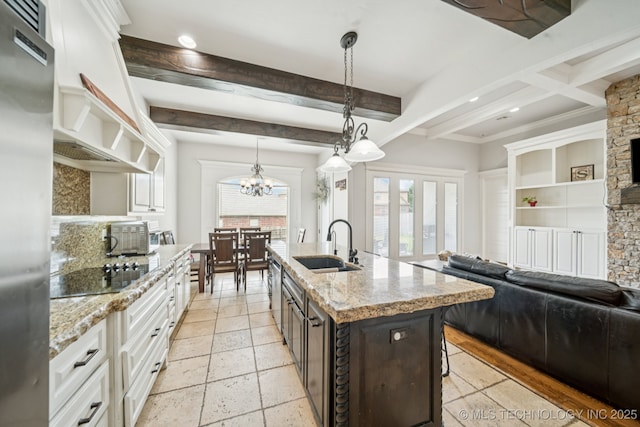 905 W Elmira St, Broken Arrow, OK 74012 - kitchen with appliances with stainless steel finishes, beamed ceiling, white cabinets, a kitchen bar, and light stone countertops