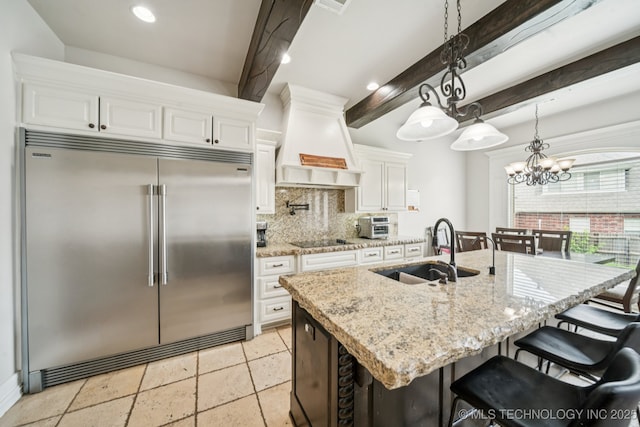 905 W Elmira St, Broken Arrow, OK 74012 - kitchen featuring stainless steel built in fridge, custom range hood, decorative backsplash, beam ceiling, and a chandelier