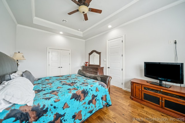 905 W Elmira St, Broken Arrow, OK 74012 - bedroom with a tray ceiling, wood finished floors, recessed lighting, ornamental molding, and ceiling fan