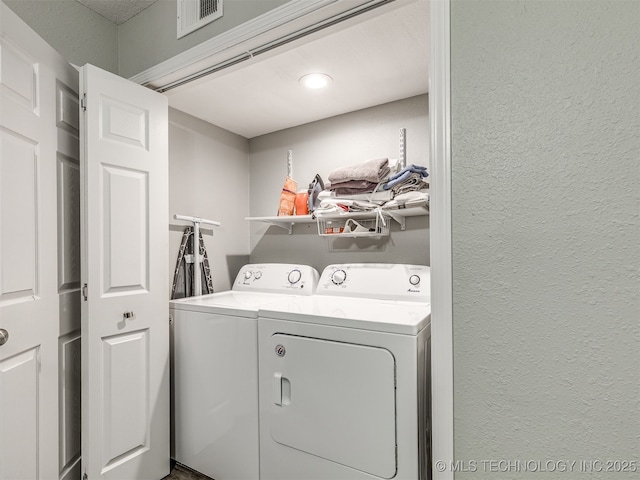 4640 E 68th St Unit 285, Tulsa, OK 74136 - washroom with separate washer and dryer and a textured wall