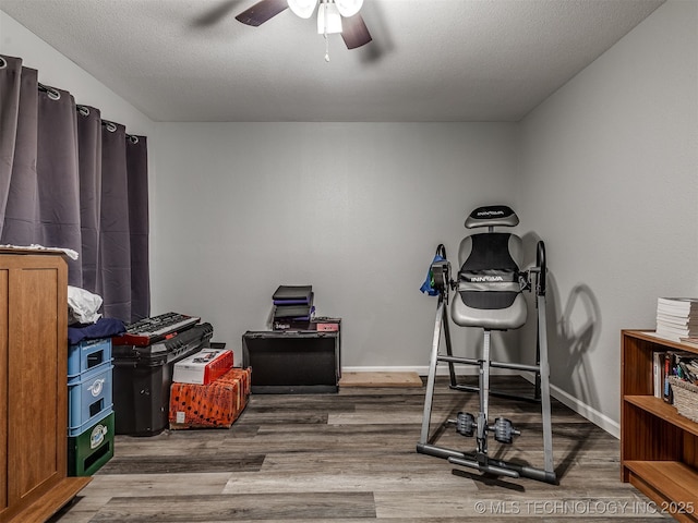 4640 E 68th St Unit 185, Tulsa, OK 74136 - workout room with wood finished floors, a ceiling fan, and a textured ceiling