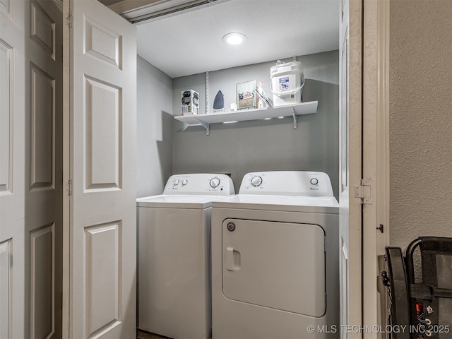 4640 E 68th St Unit 185, Tulsa, OK 74136 - laundry room with washer and clothes dryer and a textured wall