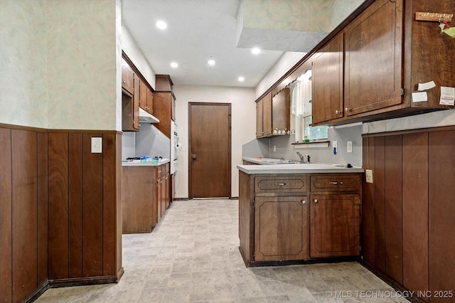 16429 E 1st St, Tulsa, OK 74108 - kitchen featuring under cabinet range hood, light countertops, and recessed lighting