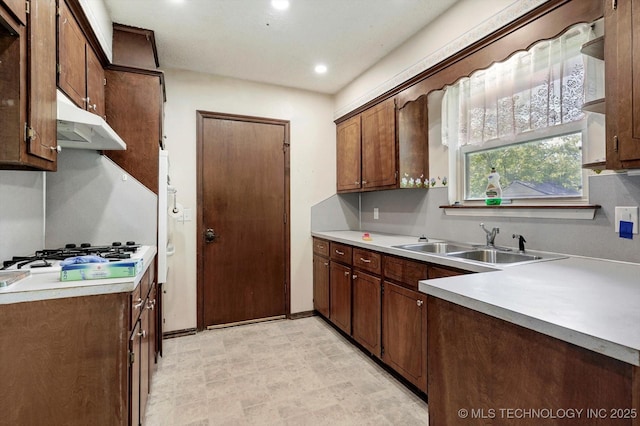 16429 E 1st St, Tulsa, OK 74108 - kitchen featuring under cabinet range hood, white gas cooktop, light countertops, and recessed lighting
