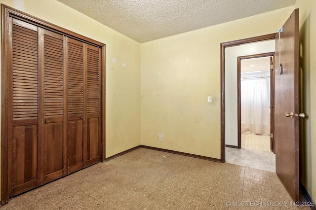 16429 E 1st St, Tulsa, OK 74108 - unfurnished bedroom featuring a closet, a textured ceiling, and light floors