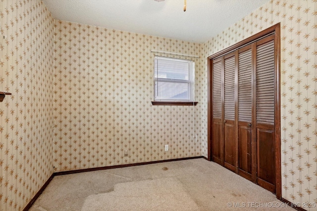 16429 E 1st St, Tulsa, OK 74108 - unfurnished bedroom featuring a closet, carpet flooring, and a textured ceiling