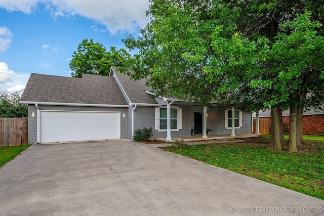 1341 Alvera Ln, Wynnewood, OK 73098 - view of front of home with driveway, a garage, a porch, and roof with shingles