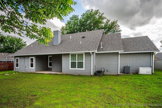1341 Alvera Ln, Wynnewood, OK 73098 - back of house featuring a chimney, roof with shingles, and a patio