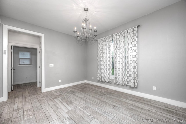 1341 Alvera Ln, Wynnewood, OK 73098 - empty room featuring a chandelier and wood finished floors