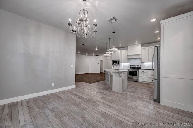 1341 Alvera Ln, Wynnewood, OK 73098 - kitchen with appliances with stainless steel finishes, open floor plan, recessed lighting, a chandelier, and light wood-style flooring