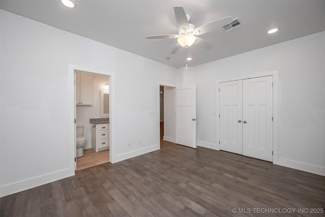 1341 Alvera Ln, Wynnewood, OK 73098 - unfurnished bedroom with dark wood-style flooring, recessed lighting, a closet, ensuite bathroom, and a ceiling fan