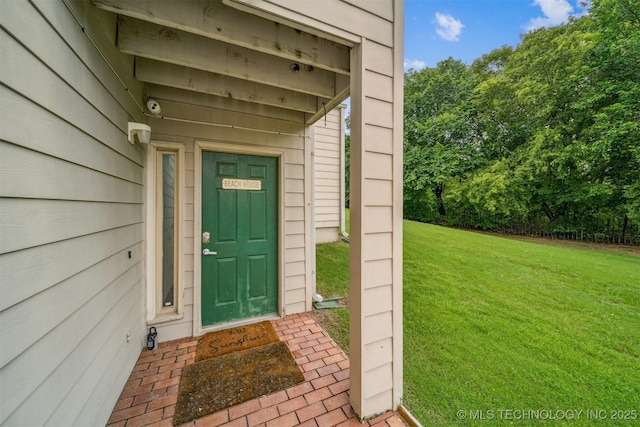 5743 E 72nd Pl Unit 11, Tulsa, OK 74136 - view of exterior entry featuring a yard and a security system
