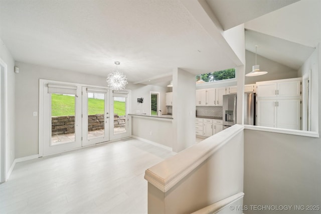 5743 E 72nd Pl Unit 11, Tulsa, OK 74136 - corridor with a chandelier and light wood-type flooring