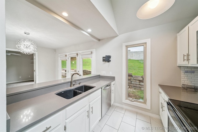 5743 E 72nd Pl Unit 11, Tulsa, OK 74136 - kitchen featuring appliances with stainless steel finishes, white cabinetry, decorative light fixtures, decorative backsplash, and recessed lighting
