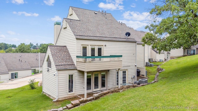 5743 E 72nd Pl Unit 11, Tulsa, OK 74136 - back of property featuring french doors, a yard, a chimney, and a shingled roof