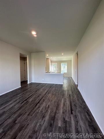 1405 E 83rd St, Broken Arrow, OK 74014 - unfurnished living room featuring dark wood finished floors and recessed lighting
