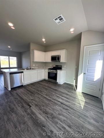 1405 E 83rd St, Broken Arrow, OK 74014 - kitchen with appliances with stainless steel finishes, dark wood finished floors, white cabinets, a peninsula, and recessed lighting