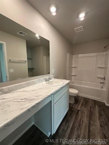 1405 E 83rd St, Broken Arrow, OK 74014 - full bathroom with wood finished floors, vanity, and bathtub / shower combination